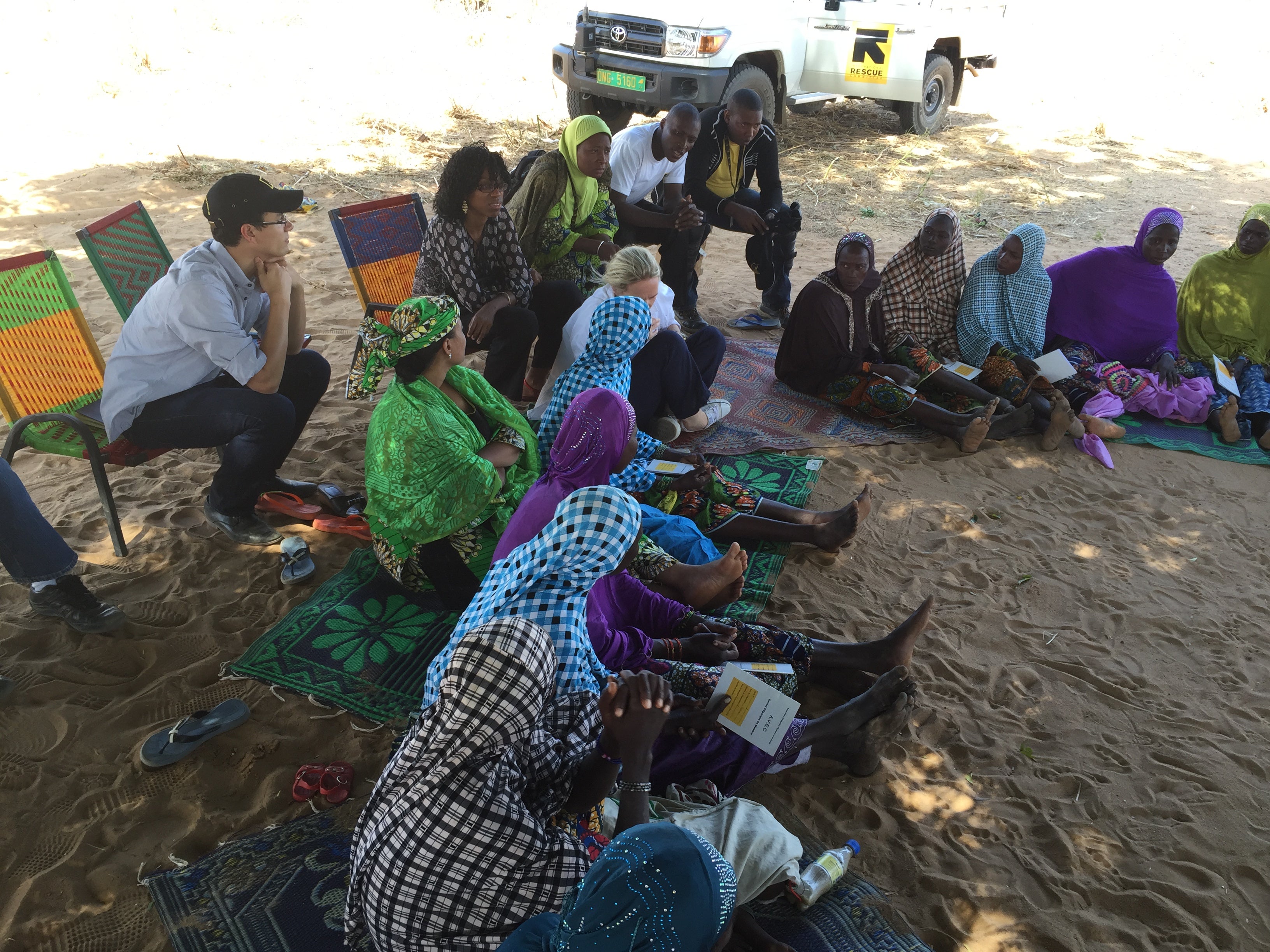 Ben Wise in a high poverty area of Niger attending a women's microfinance group's weekly deposit meeting organized by IRC