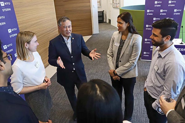 Image of Andre Koo with tech MBA students 