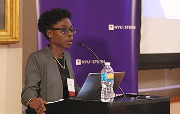 Nana Apraku speaks at a podium