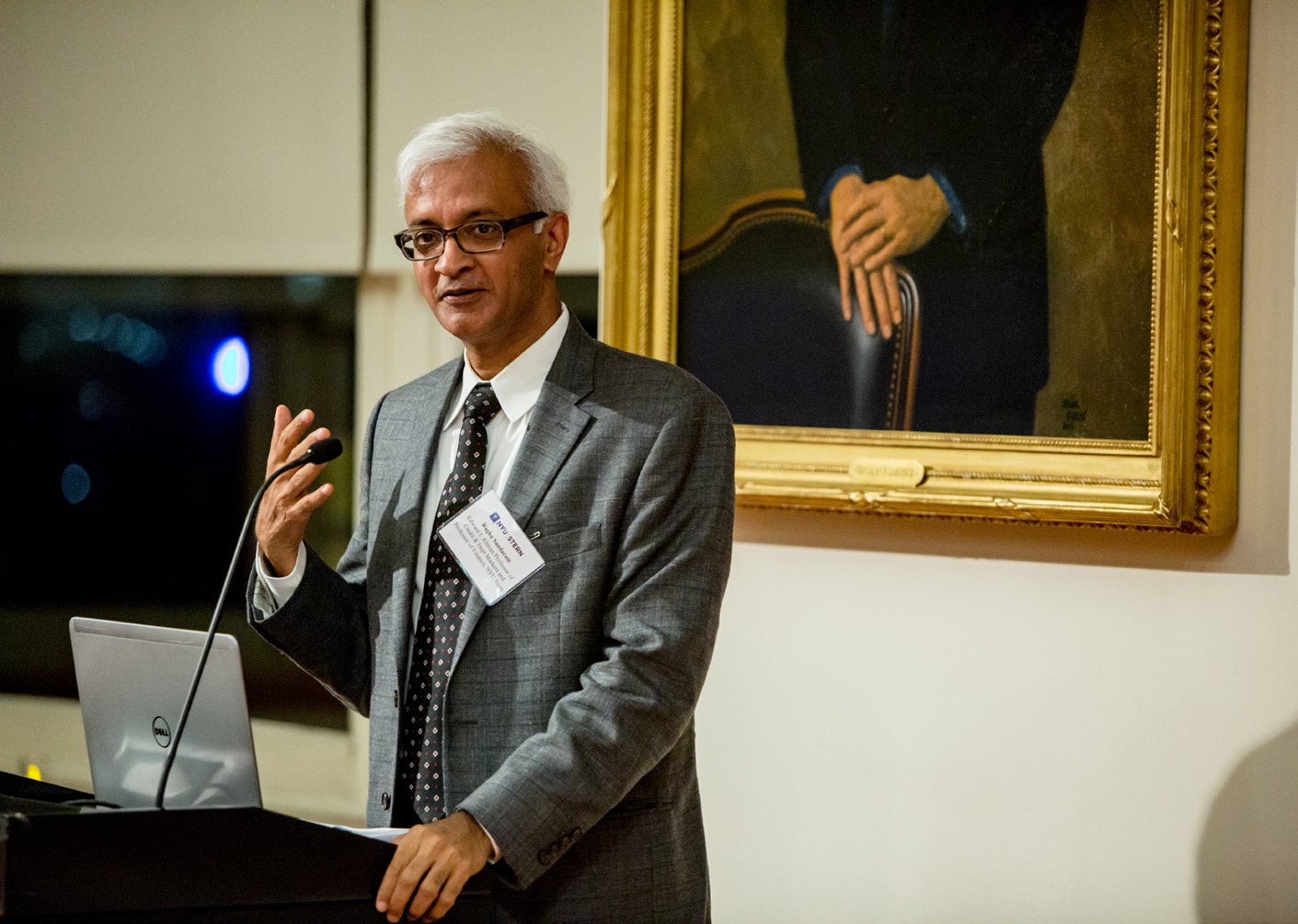 Photo of Dean Sundaram speaking at a podium