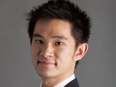 A headshot of MBA student Gabriel Ng with a gray background. 