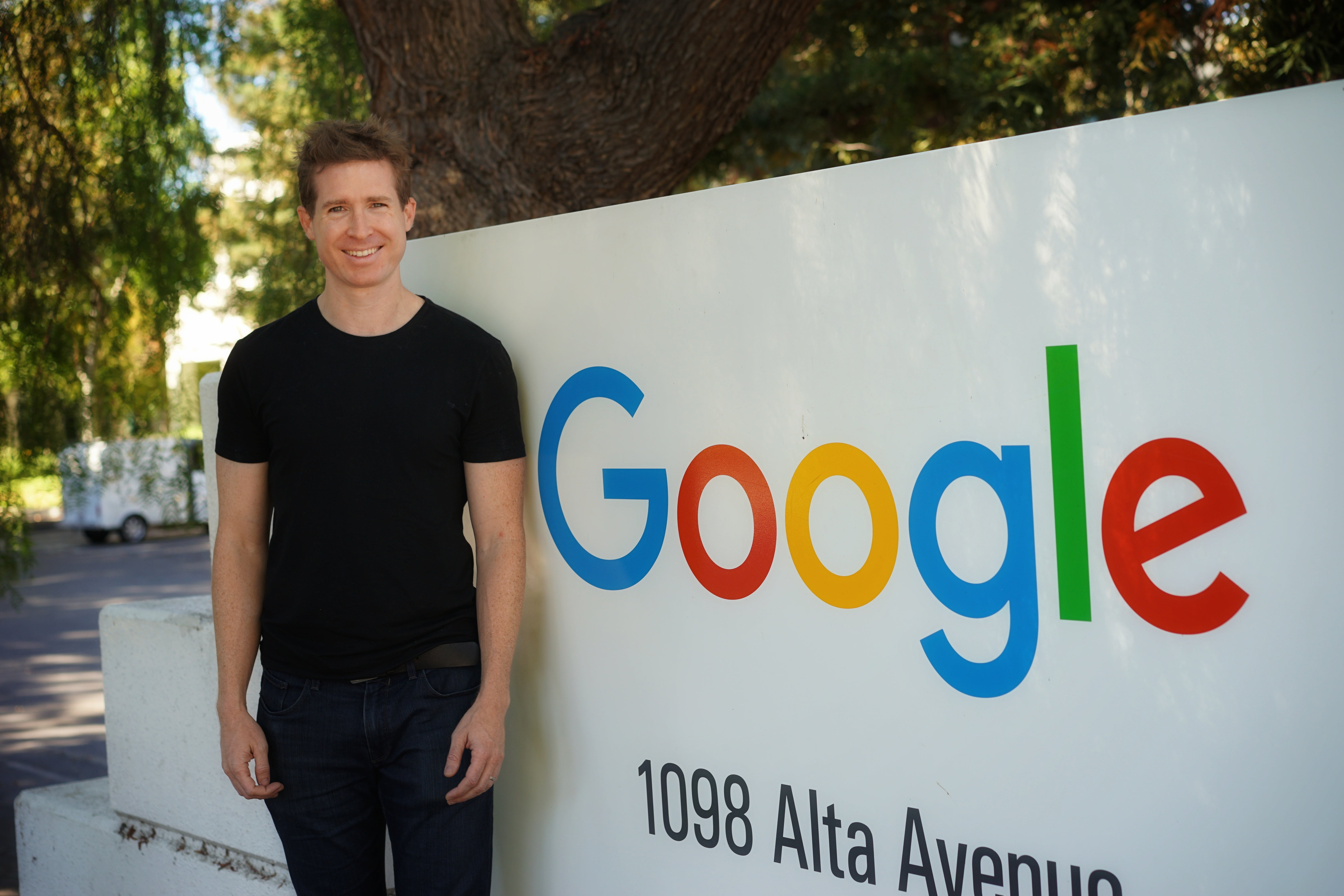 Juston Payne, MBA '12, in front of Google sign