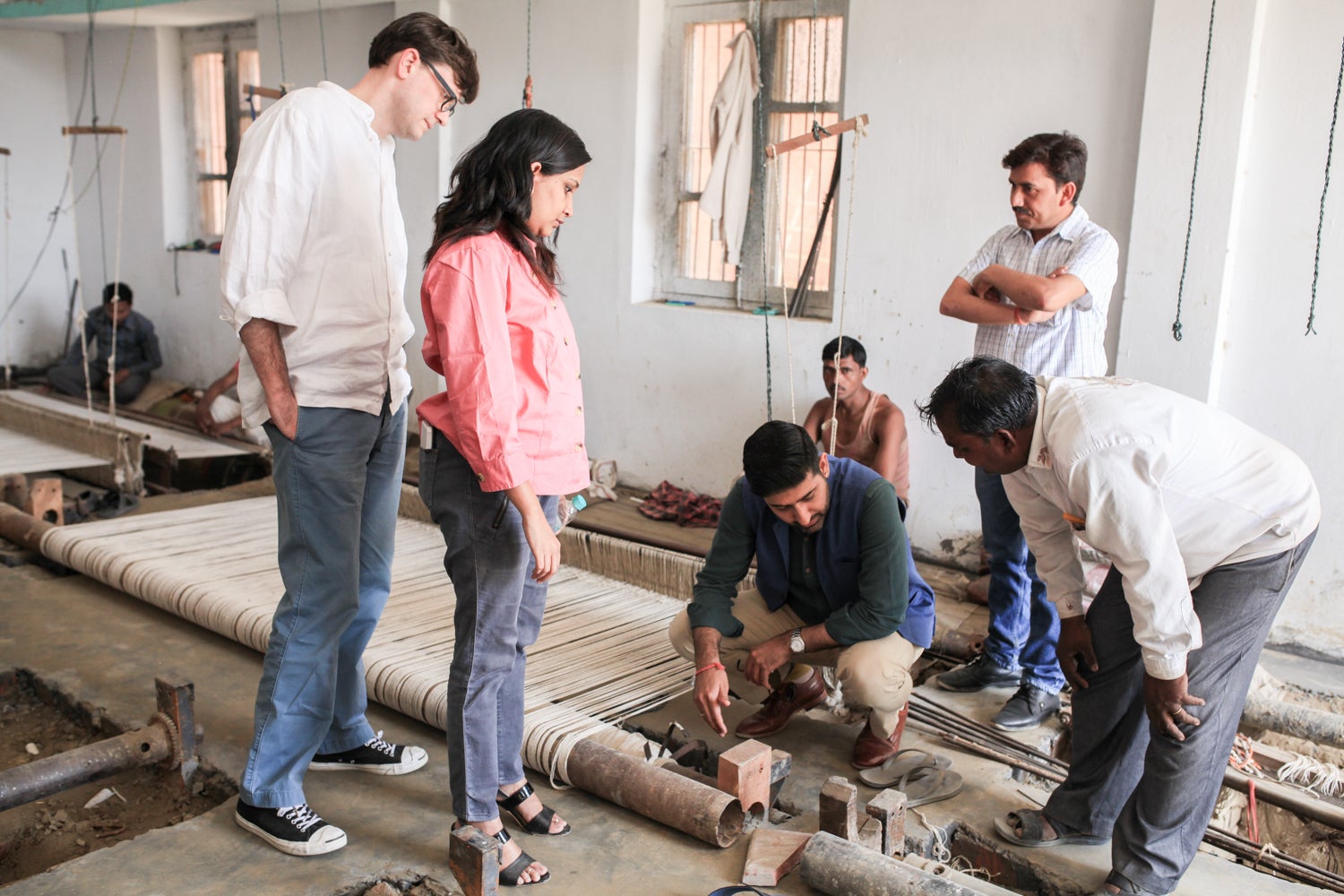 Photo of Van Bergen working on improvements to a weaving workshop