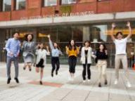 Students are pictured jumping after the NYU Stern and NYU Shanghai orientation. 