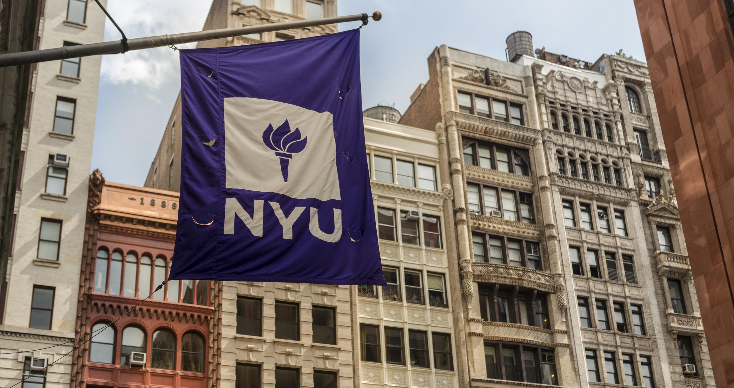 NYU flag against cityscape
