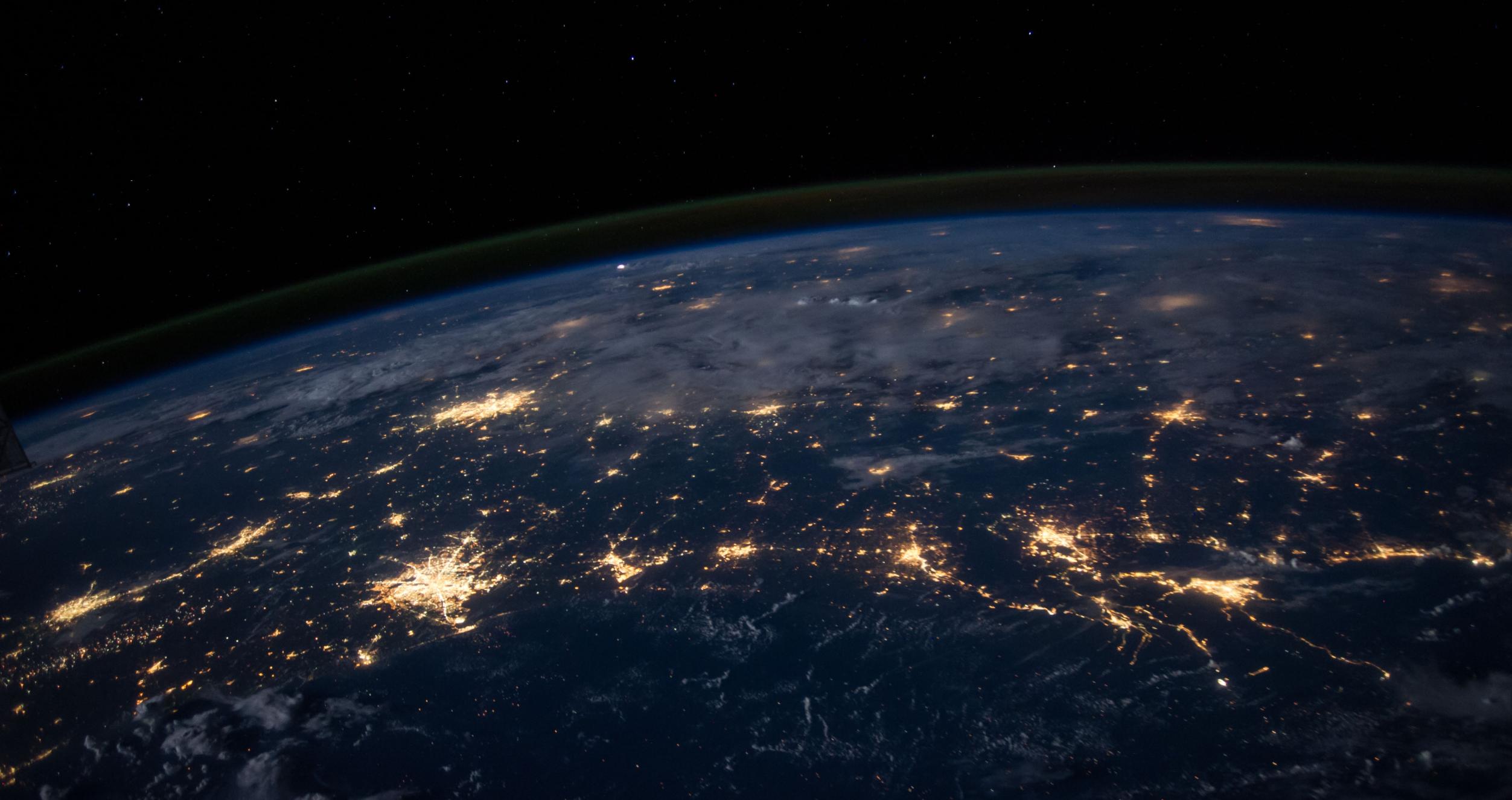 Photo from space of earth at night with city lights 