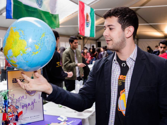 Student holding up globe at Passport Day