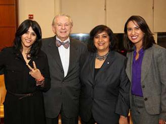 Dean Menon posing with Etka Kapoor and two students