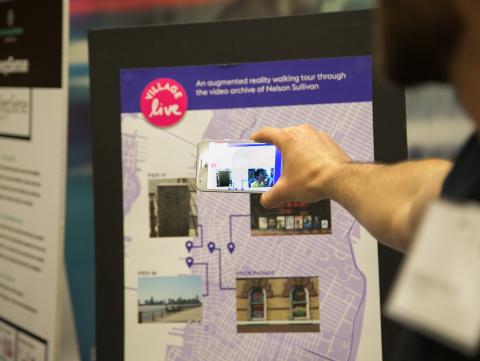 Person holds phone up to an interactive map