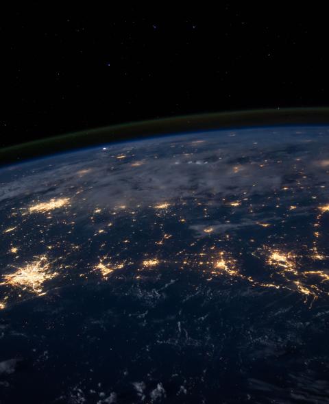 Photo of earth from outer space with cities lit up by electrical lights 