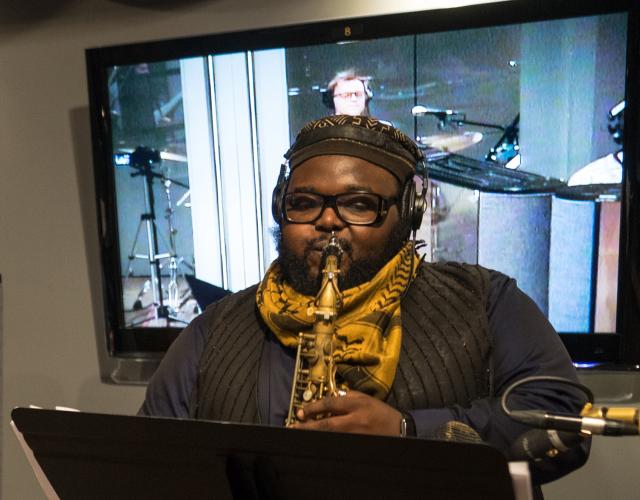 A student plays the saxophone at an NYU studio