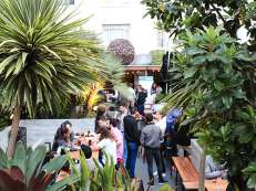 people mingling on the patio at 620 jones in san francisco