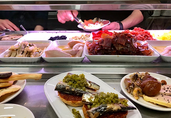 Diners help themselves to tapas at the restaurant Quimet y Quimet in Barcelona. 