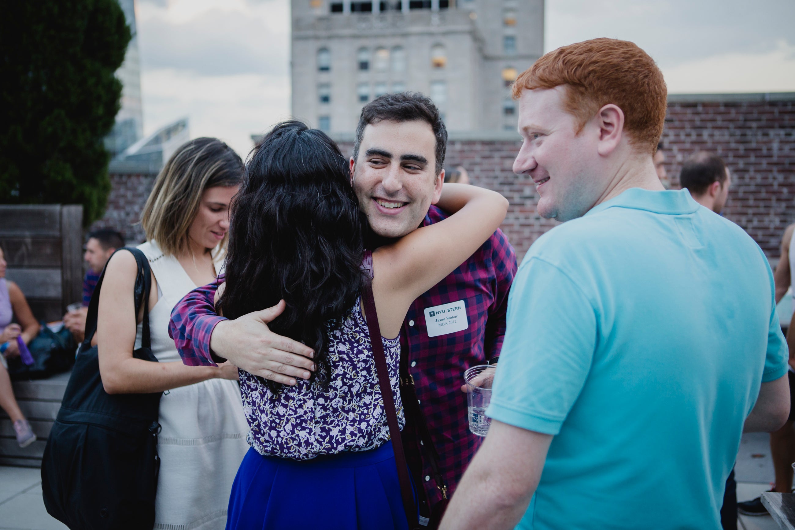 Alumni gather at an Outclass rooftop soiree