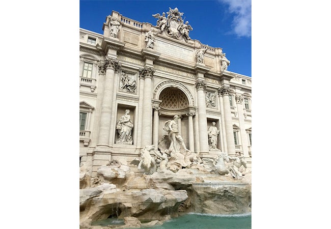 Stone figures are etched into the stone surrounding Trevi Fountain in Rome, Italy. 