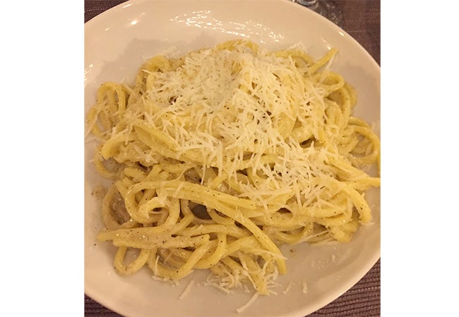 A close-up of a dish of cacio e pepe pasta served in Rome, Italy. 