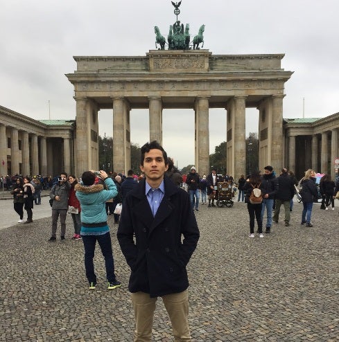 Undergraduate business student Aldo Gonzalez stands in front of Brandenburg Gate in Berlin while studying abroad.