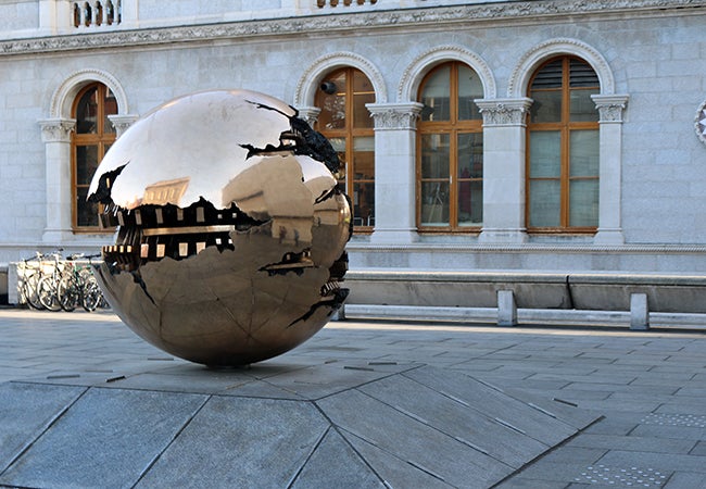 A bronze sculpture spherical in shape titled Sfera con Sfera (or sphere within a sphere) in Ireland. 