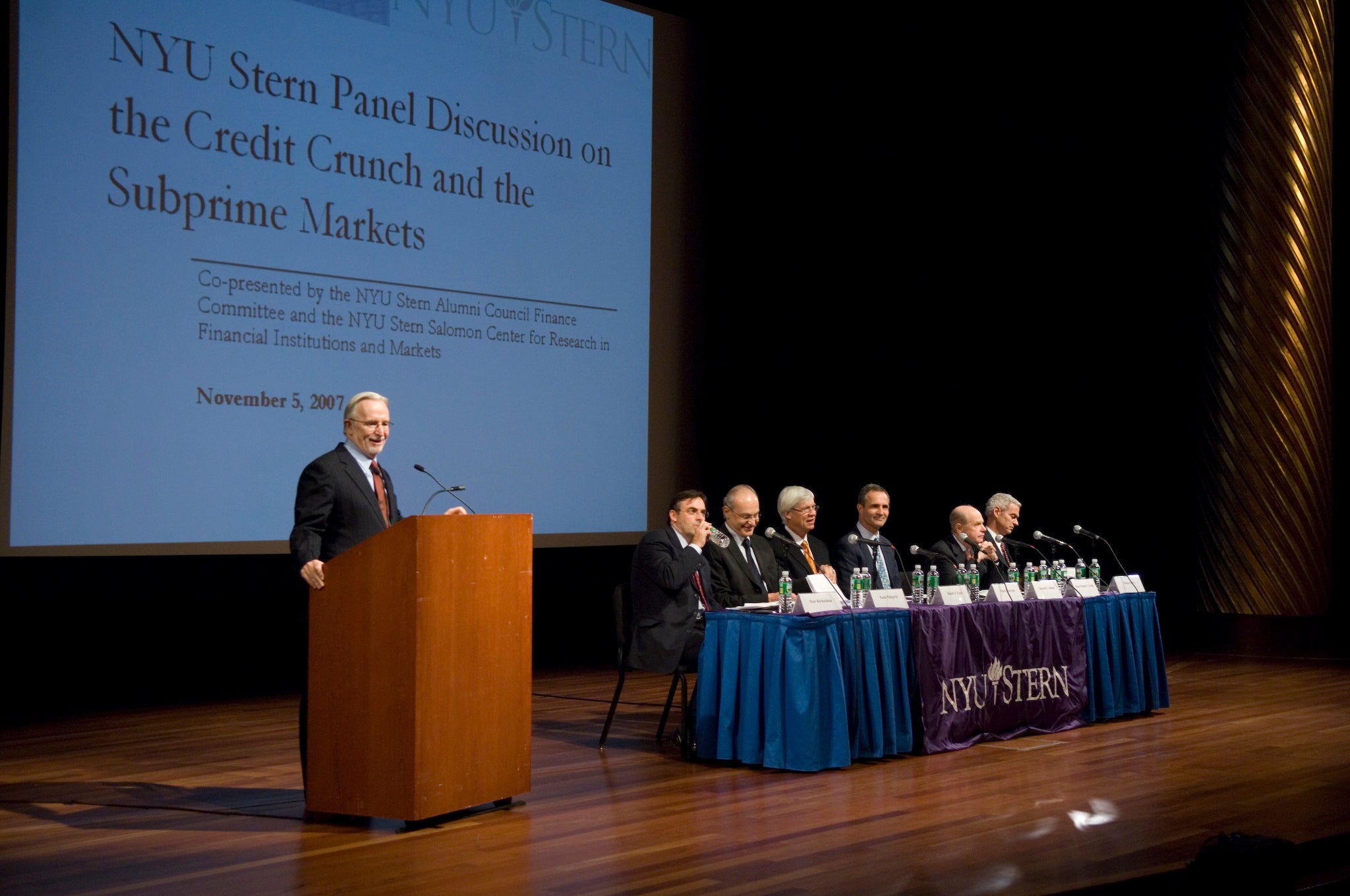 Thomas F. Cooley speaks at a lectern during a panel discussion