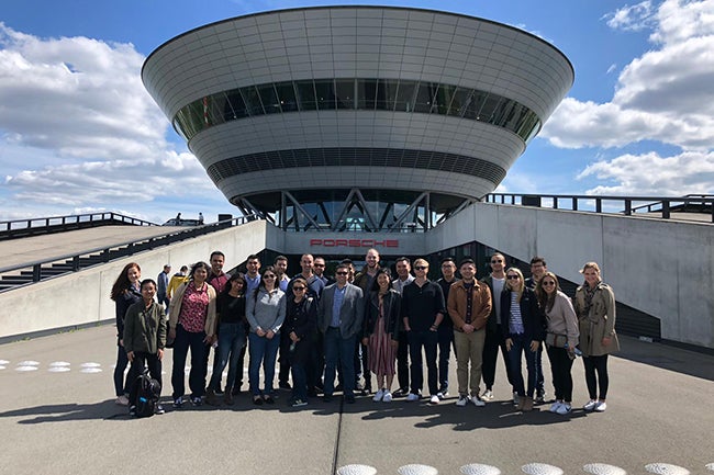 MBA Students pose for a photo outside the Porsche factory in Leipzig, Germany.