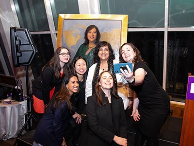 Dean Menon and dean's office team take a selfie with the portrait