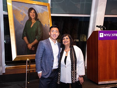 Dean Menon and a student pose with the portrait