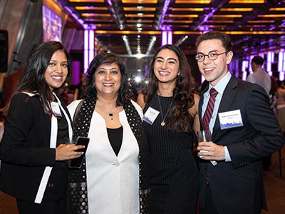 Dean Menon poses with students