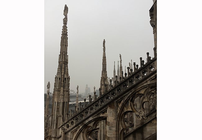 A view looking out over ornate stonework from the Duomo in Milan, the highest point in the cathedral. 