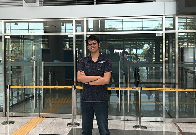 Undergraduate business student Jesse Aguilar poses during his travels while studying abroad in Hong Kong.