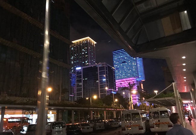 Buildings adorned with neon lights dot the skyline of the city of Macau.