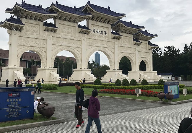 The bright white facade of Chiang Kai-shek Memorial Hall is complemented by a blue tiled roof.