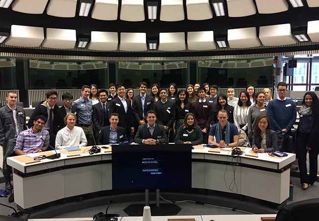 Students gather for a group photo in a large room at the European Parliament in Brussels. 