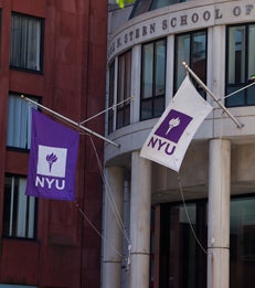 NYU flags outside of the Henry Kaufman Management Center