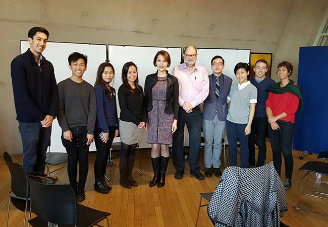 MBA student Kimberly Rodriguez and other students gather for a group photo with Geraldine Roman.