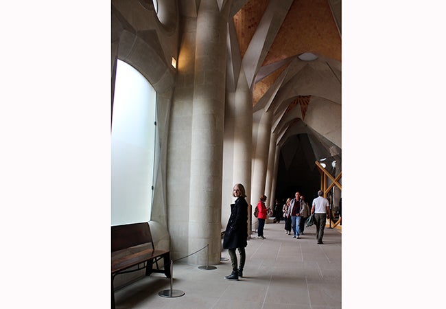 Undergraduate student Michelle Enkerlin looks back while walking through a cavernous building. 