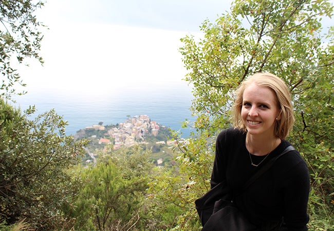 Undergraduate student Michelle Enkerlin pauses for a photo at a spot that overlooks a village in Cinque Terre, Italy. 