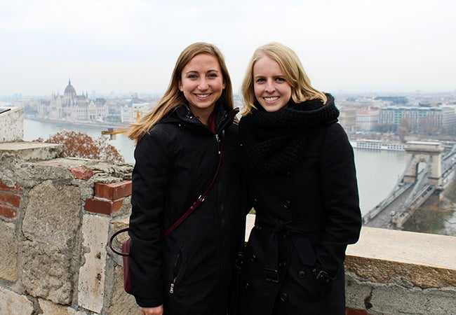 Undergraduate business student Michelle Enkerlin stands before a river in Budapest with a friend while studying abroad in Europe.