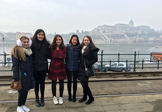Undergraduate business student Natasha Lim poses with friends along the Danube River in Budapest. 