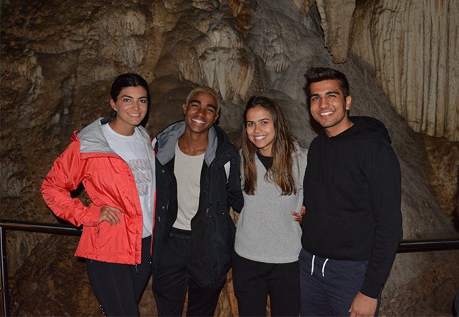 Undergraduate business student Dimitri Pun poses with three friends while studying abroad in Sydney, Australia. 