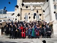 TRIUM graduates throw their caps in the air