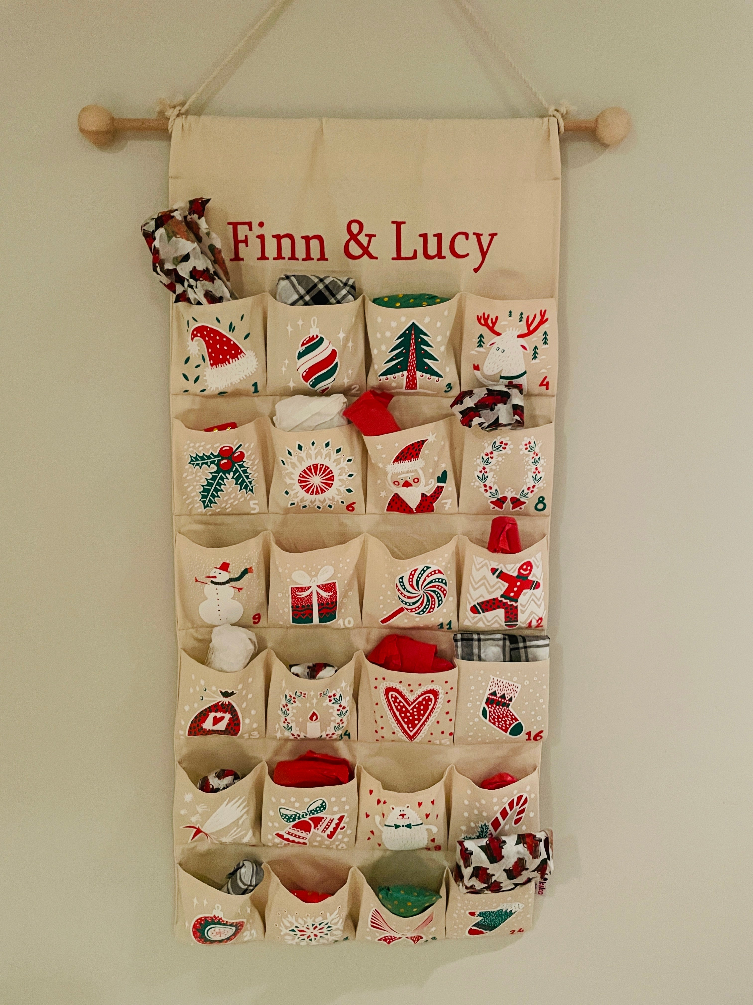 A handmade advent calendar features the names "Finn & Lucy"