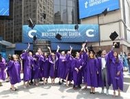 Student throw their cap in the air outside of MSG before graduation.
