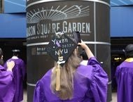 A student takes a selfie outside of MSG on May 20 to celebrate graduating.