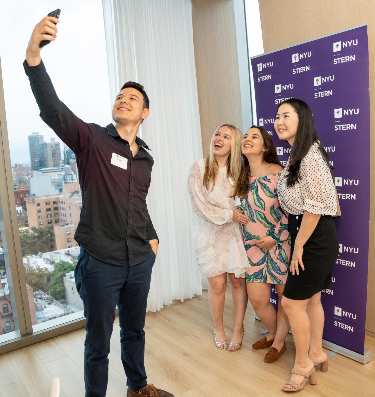 Stern alumni pose for a selfie