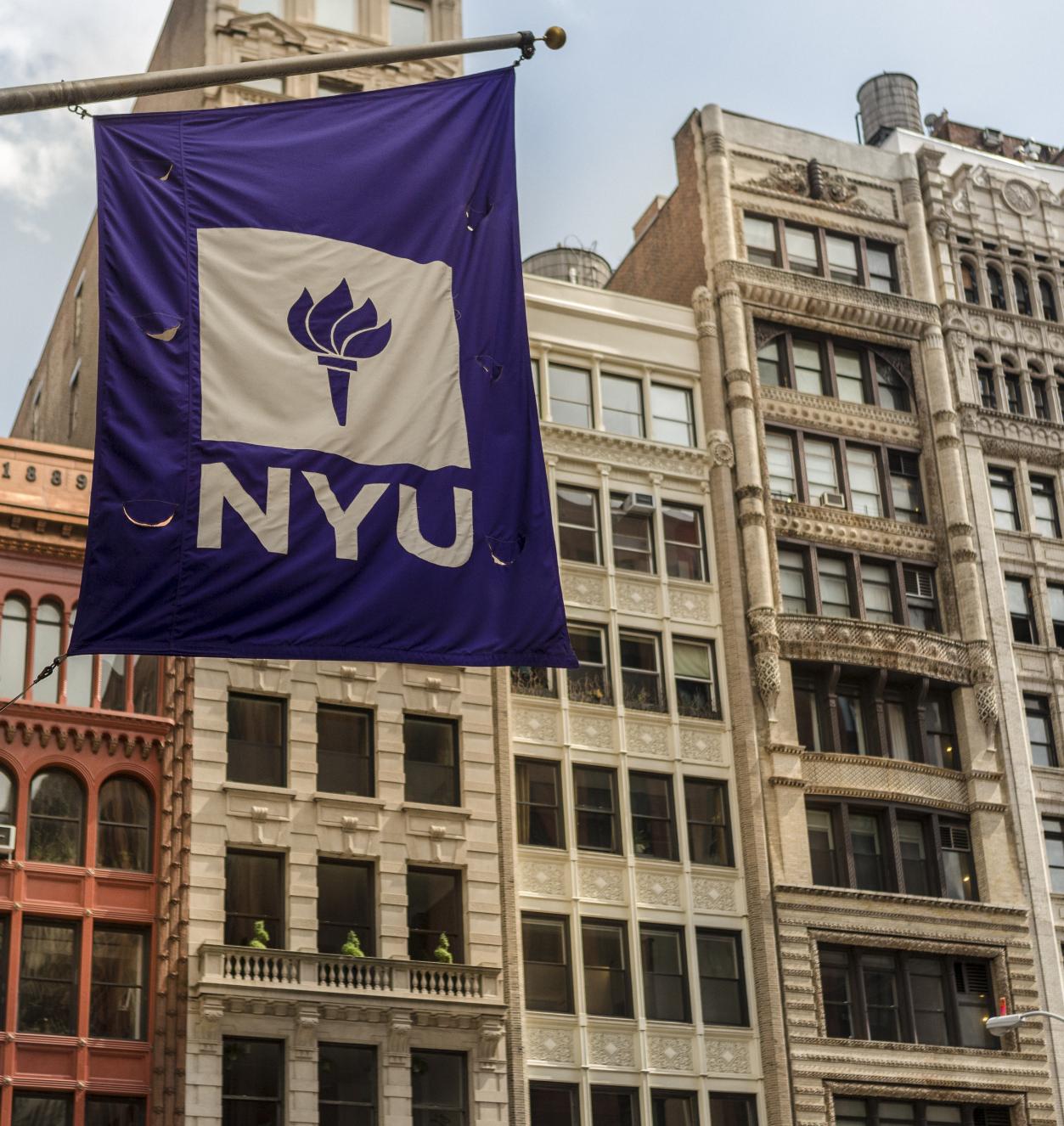 NYU flag against cityscape