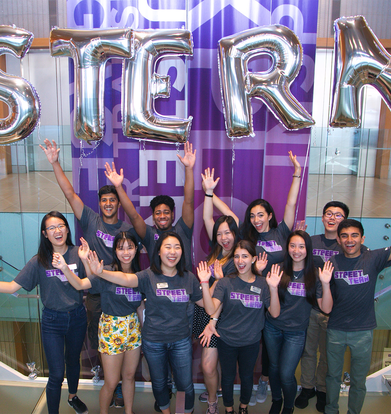 Students cheering in stairwell