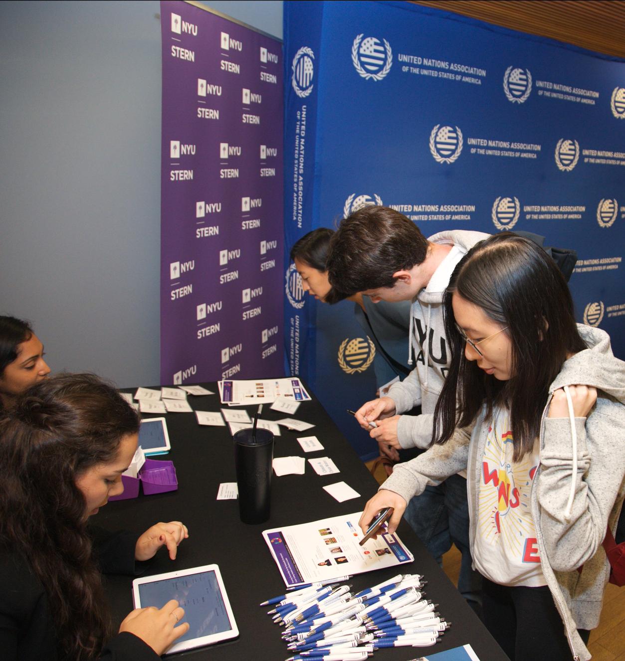 Students attending an SDG event Students checking in at a table for an event