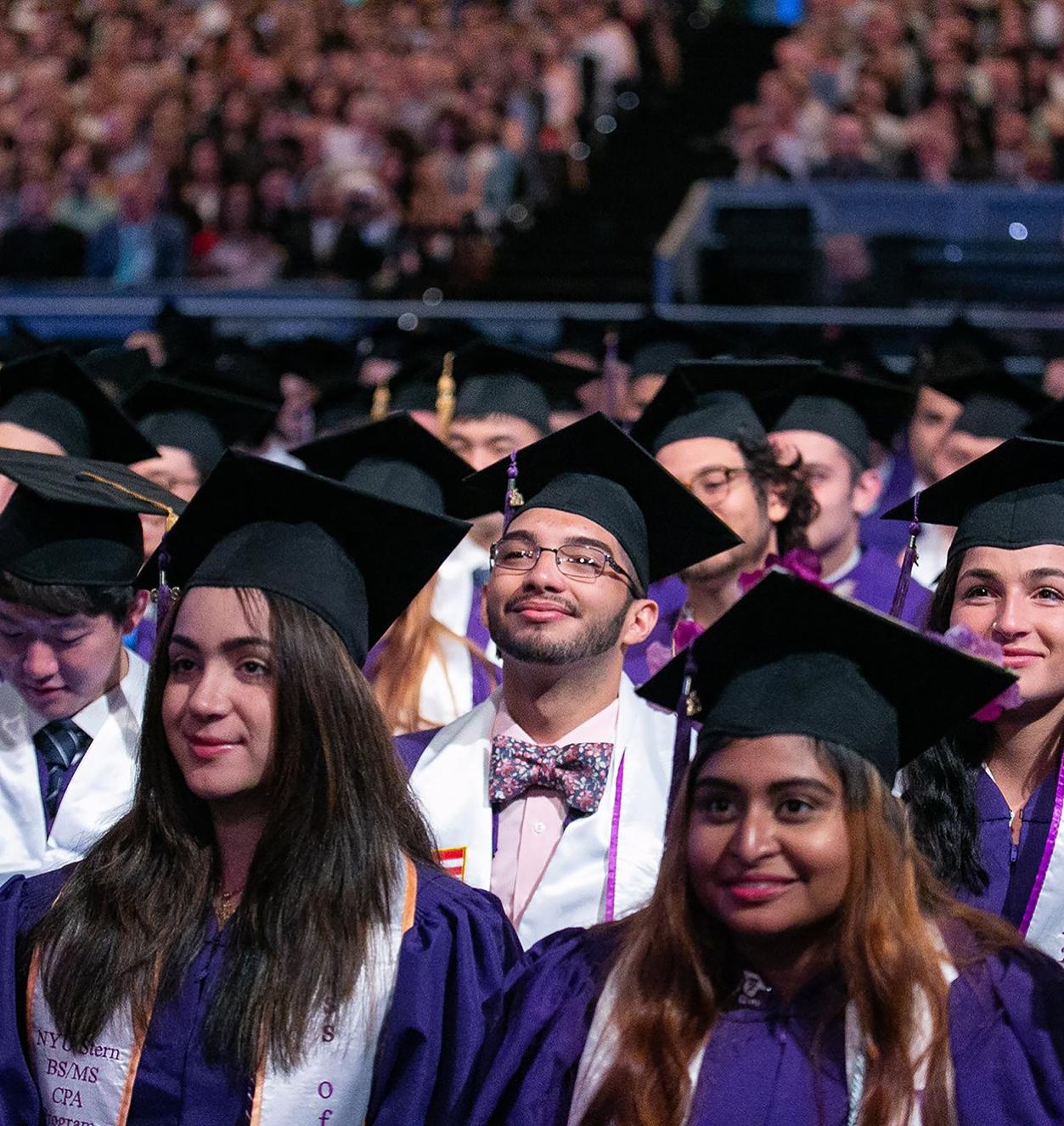 Graduates in caps and gowns looking up