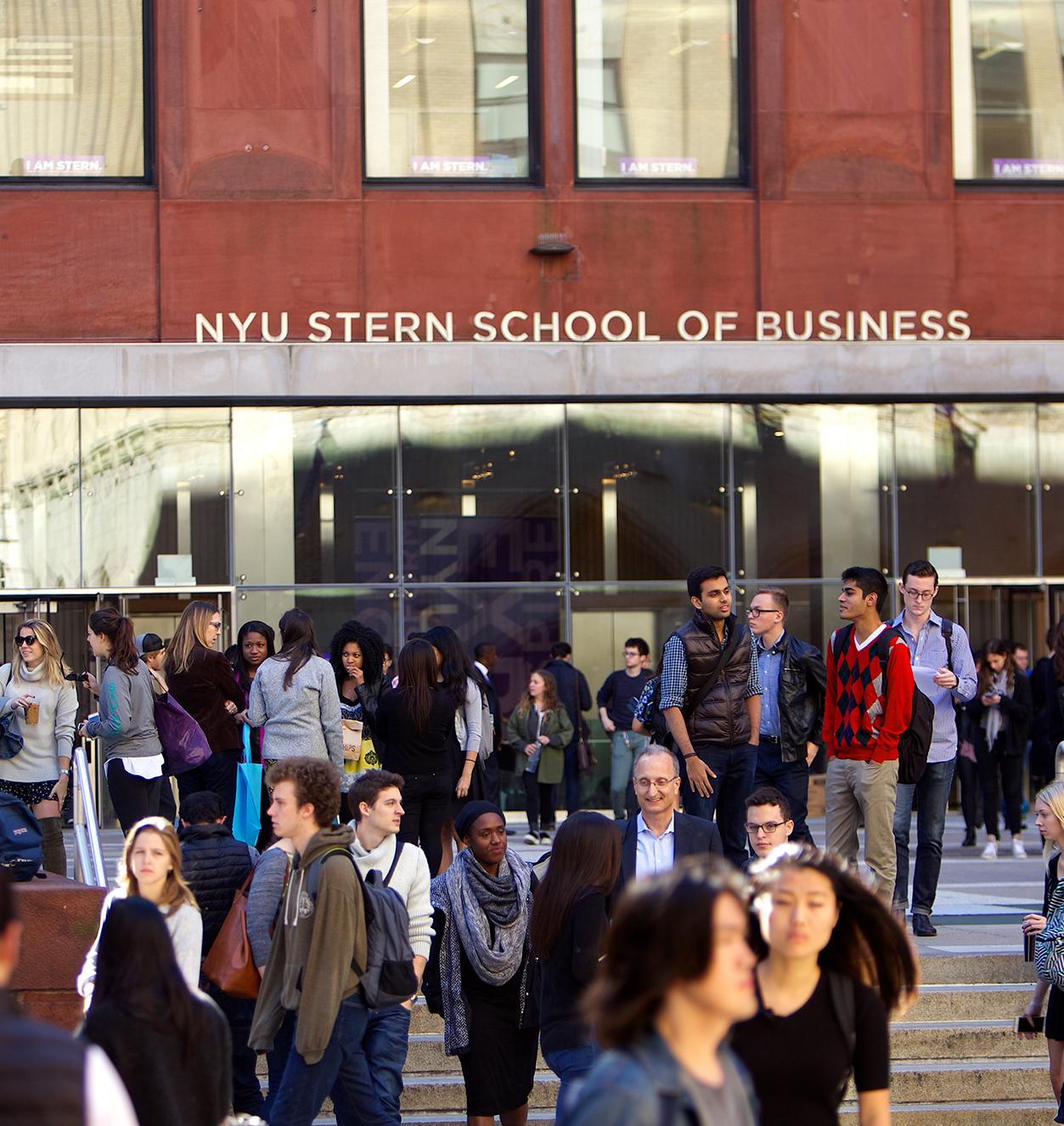 NYU Stern students gather in front of Tisch Hall on a sunny day in New York City