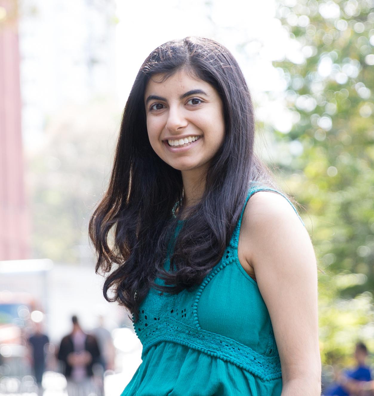 Shivangi Khanna sitting in Washington Square Park